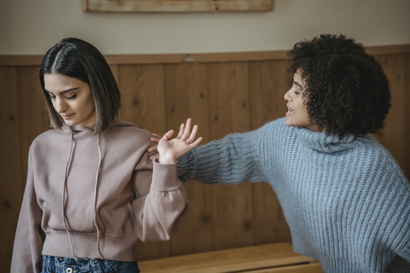 Diverse women quarreling in room